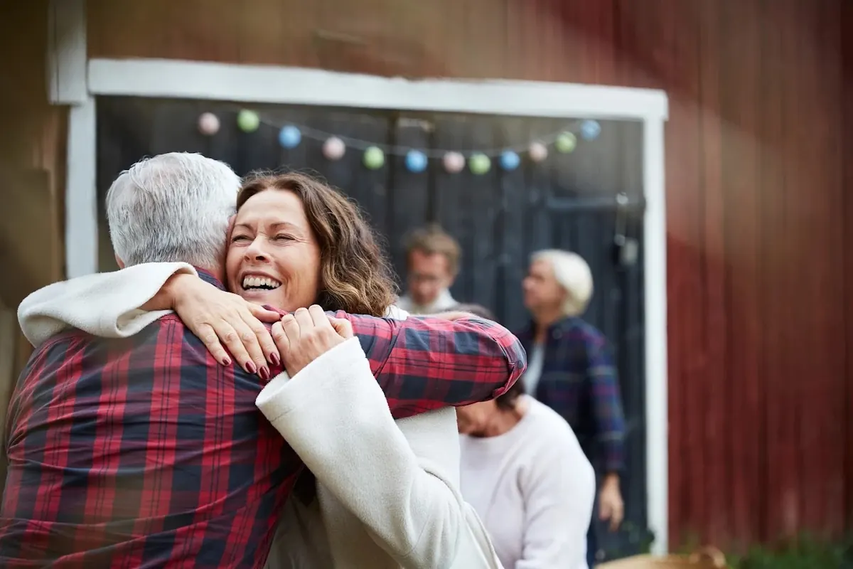 A daughter hugging her father, relieved and at ease